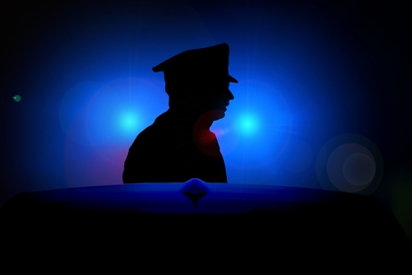 Police officer silhouette in lights