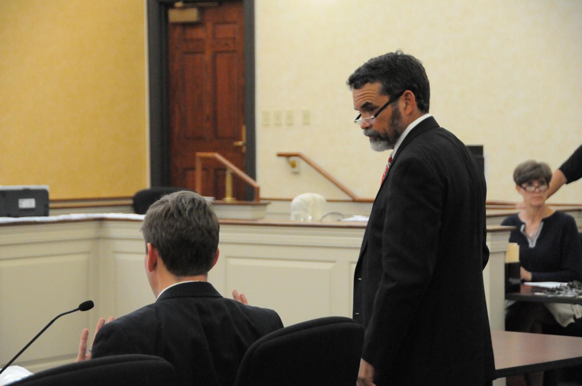 two men at a speaker pulpit